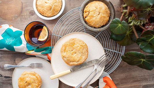 four pies plated with knife and fork