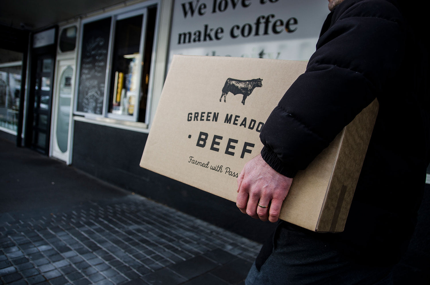 Man holding Green Meadows beef box