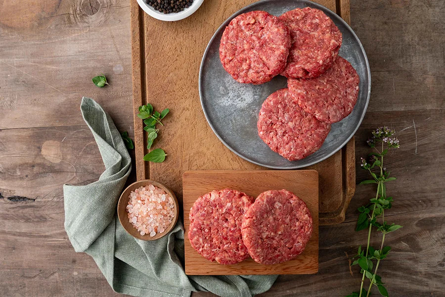 raw beef patties styled on table setting