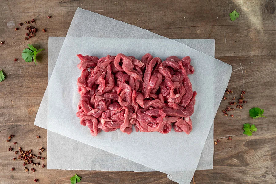 raw beef stir fry on baking paper