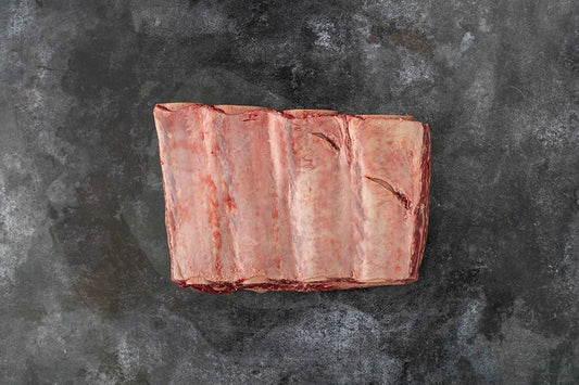 Beef Short Rib piece sitting on dark marble