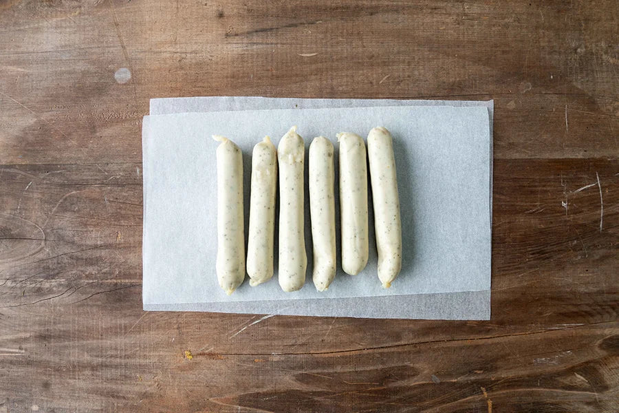 chicken sausages on baking paper