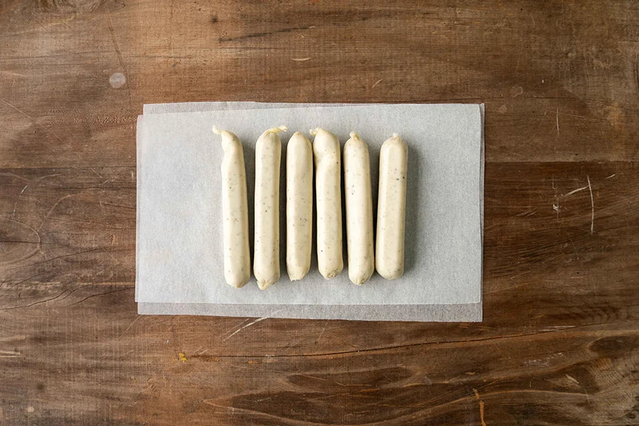 chicken sausages on baking paper