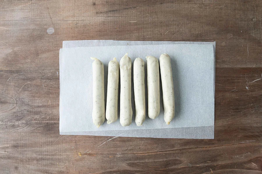 chicken sausages on baking paper