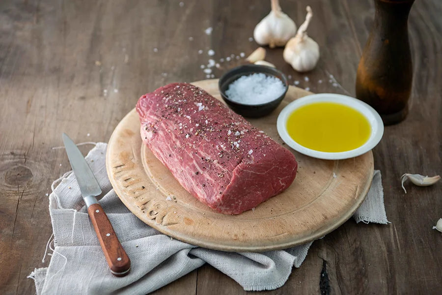 an angus beef eye fillet piece on a chopping board