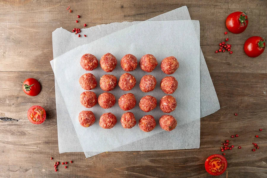 Mini beef meatballs sitting on baking paper