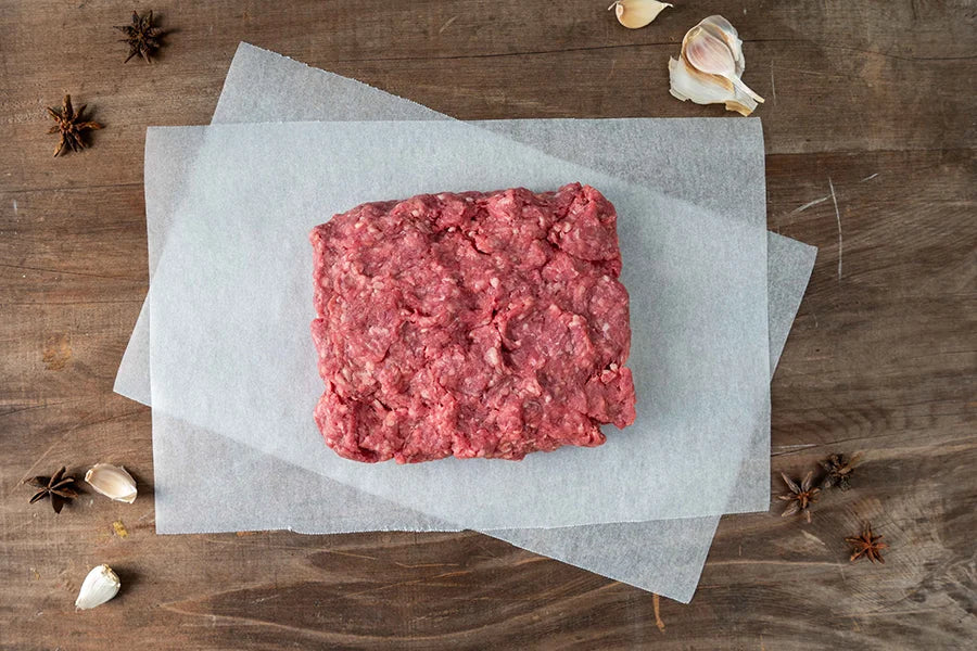 Beef mince sitting on wooden tabletop