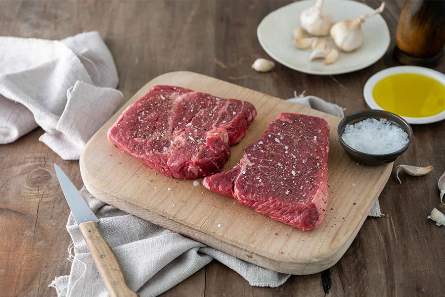 rump steak on a chopping board with salt