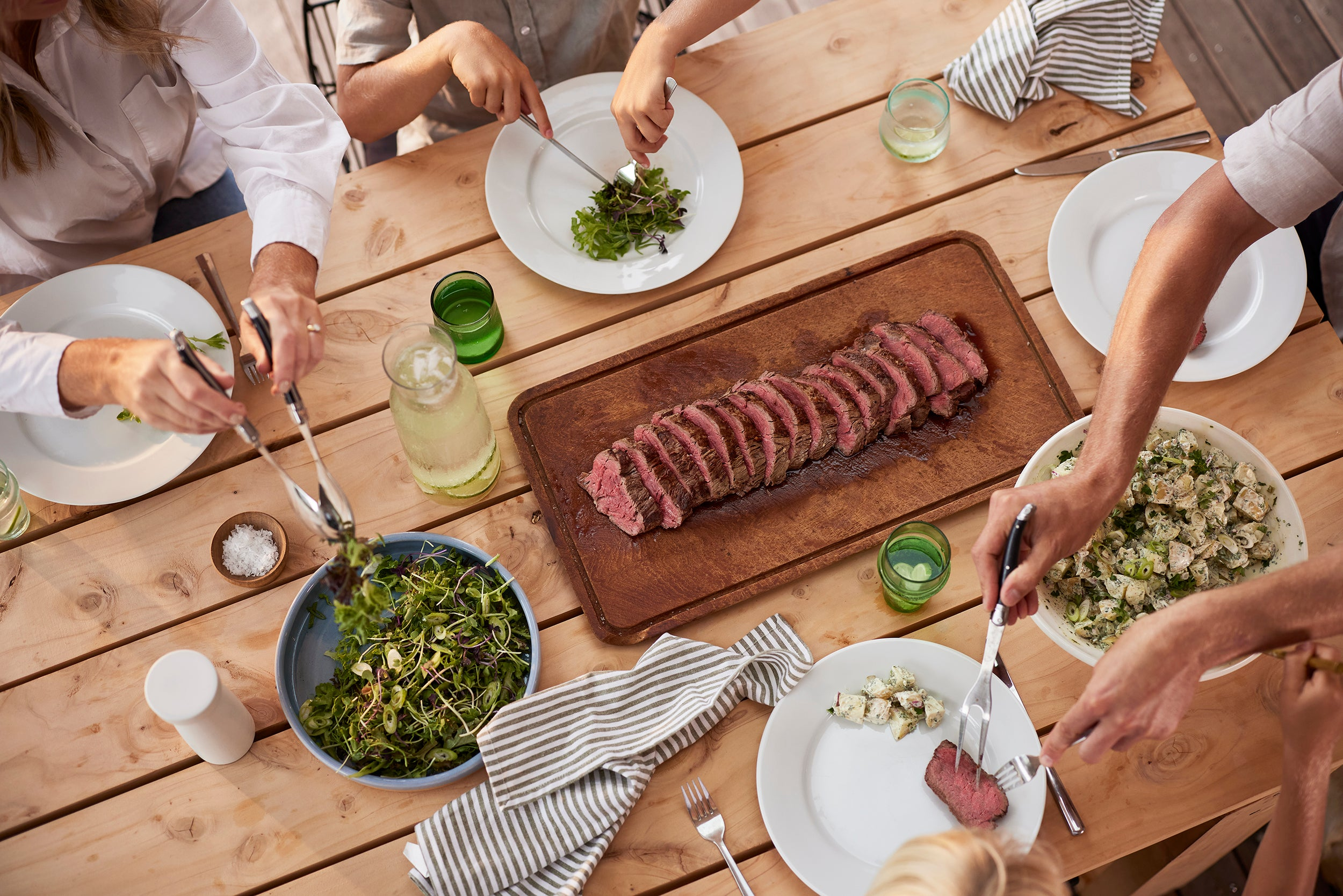 Family serving beef and salad