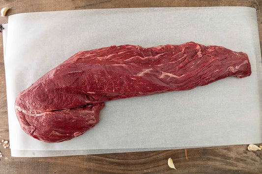 Whole Angus Beef Eye Fillet sitting on baking paper