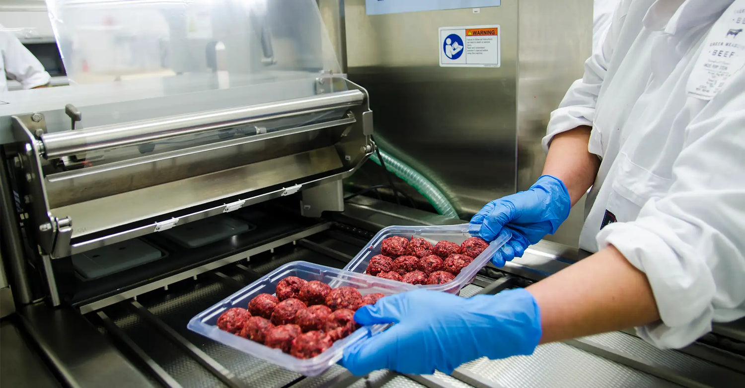 Trays of meatballs being packaged